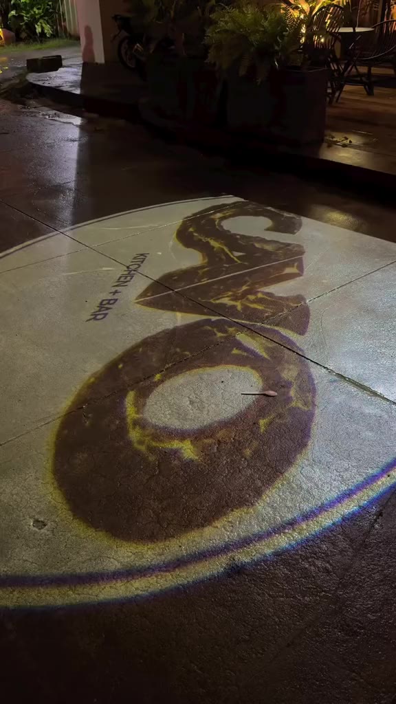 The CAVO logo on the pavement, the Welcome to CAVO sign and the OPEN sign at night
