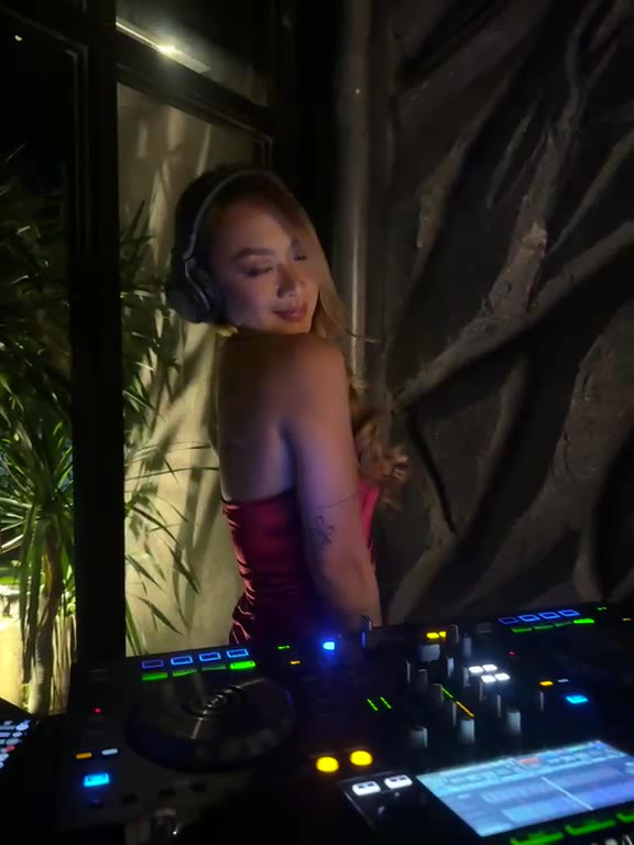 A DJ in red at the decks at Cavo