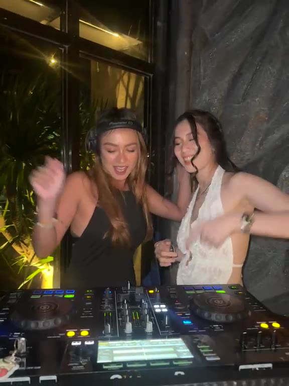 Two DJs at the decks at night at Cavo