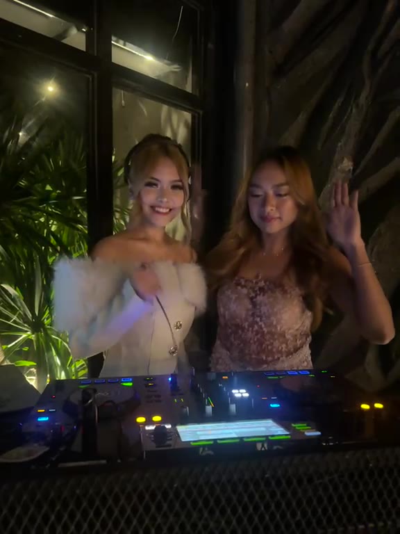 Two DJs smiling at the decks at Cavo